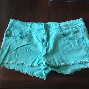 Sea-foam green denim shorts with fringe